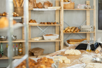 Bakery kitchen interior - raw dough on the table for making baguettes and croissants