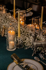 Christmas and Holiday decor in a cozy home with candles, plates, wine glasses and champagne
