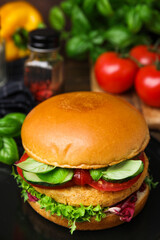 Delicious vegan burger with chickpea cutlet on table, closeup