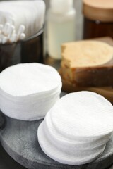 Many cotton pads and other toiletries on table, closeup
