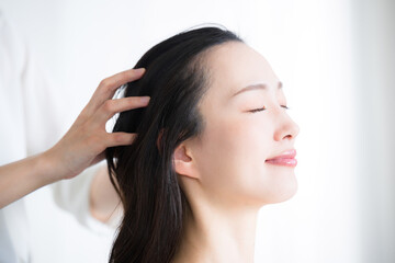 Close-up of an image of a head massage or head massage with eyes closed