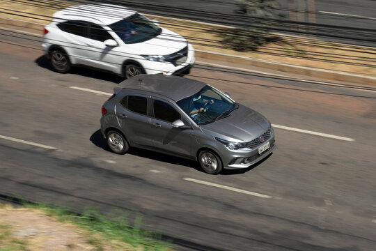 Silver Fiat Argo in city traffic, Compact hatchback in movement, High Resolution Panning Shot
