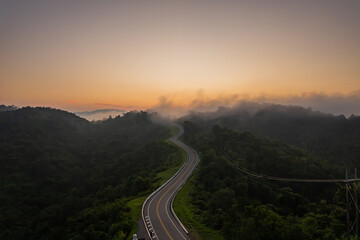 Beautiful sunrise over the mountains and the road No 3, which is famous in Nan Province, Thailand