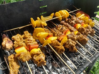 Barbecue grills at barbecue party in holiday. BBQ with Beef, potato slice, and vegetables. 