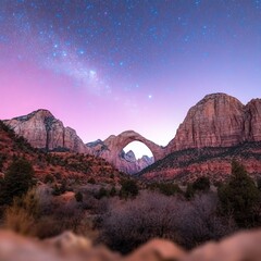Obraz premium A natural archway framed by mountains with the Milky Way in the night sky.