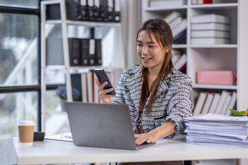 Laptop, Phone business woman use phone laptop in the office for online email communication corporate review. Technology hr with computer and phone for reading company on internet,