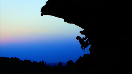 Incredible rock climber silhouette at dusk