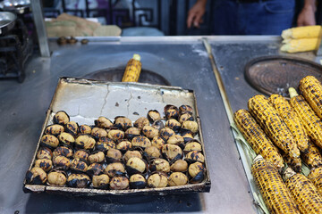 Roasted street chestnuts and corn at a street stall. selling fried corn and chestnut outdoor in Istanbul, Turkey