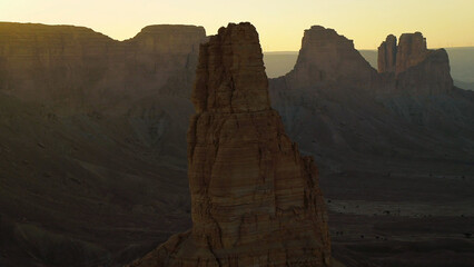 Huge, tall red rock in beautiful Saudi Arabian desert at dusk