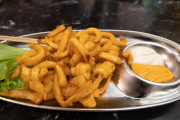 Closeup view of the curly French fries or potato chips.
