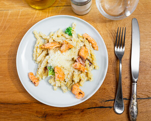 Plate of pasta cooked with salmon and bacon. Traditional Italian food