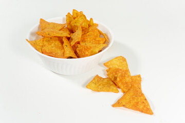 Corn tortilla chips in white bowl isolated over white background.