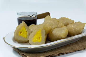 Pempek or mpek-mpek is a delicacy from Palembang, South Sumatra. It is made of fish and sago flours and served together with a dark, rich sauce called cuko.