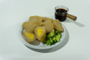 Pempek or mpek-mpek is a delicacy from Palembang, South Sumatra. It is made of fish and sago flours and served together with a dark, rich sauce called cuko.