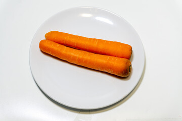 carrots on white plate isolated on white background