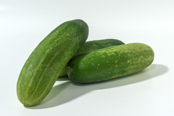 Green cucumber isolated on white background. Green cucumbers texture template arranged and harvested