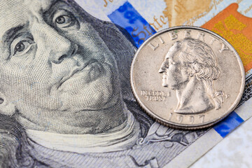 A silver coin with the word Liberty on it is on top of a piece of paper with the