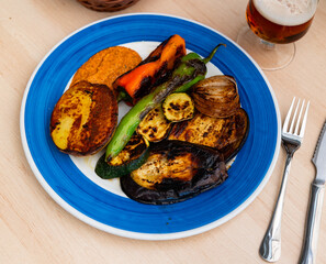 Grilled vegetables prepared according to Catalan traditions, served with romesco sauce