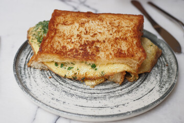 A delicious and beautifully presented omelette served with toast on a rusticstyle plate