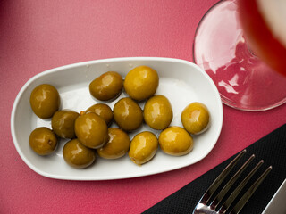 Delicious spanish tapas from marinaded green olives at plate