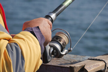 Fisherman with rod, spinning reel ,