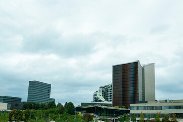 Fototapeta premium View of modern skyscrapers in city on cloudy day