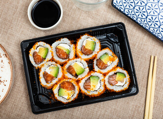 Japanese california roll masago caviar with salmon, avocado and cheese with soy sauce