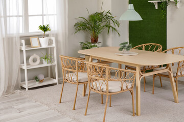 Interior of stylish modern dining room with table and chairs