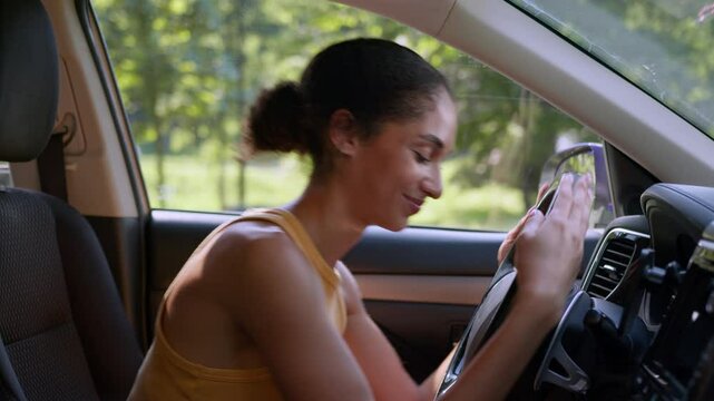 Happy African American woman buyer female sit luxury new car auto hugging wheel steering owner automobile buying enjoy businesswoman vehicle embrace hug rent service test drive cuddling girl business