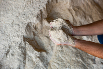 Close up of soy flour in the hands of farmer. Feed for cows and calves