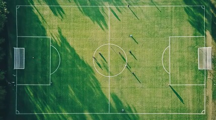 Aerial view of a soccer field with players and goals.