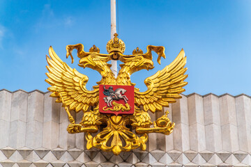 Double golden eagle. Coat of arms of Russia on the roof top of the Big Kremlin concert hall