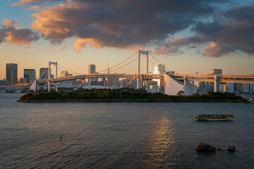 Fototapeta premium View of the automobile suspension Bridge over the North Tokyo Bay Rainbow Bridge from Odaiba Island at sunset, Tokyo, Japan