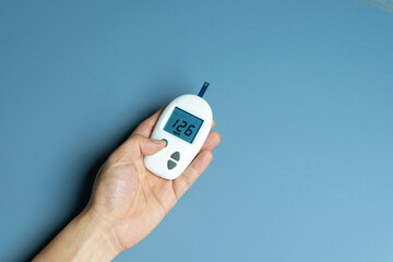 hand of woman check diabetes and high blood glucose monitor with digital pressure gauge. Healthcare and Medical concept	

