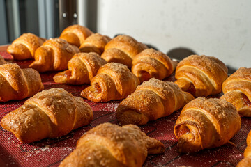 Croissants or bagels with jam on the production floor. Mini bakery, sweet pastries. High quality photo
