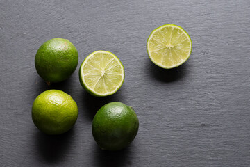 Fresh Green Limes On A Black Slate Background