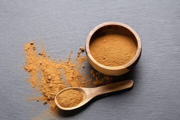 Cinnamon Sticks and Powder on Gray Slate