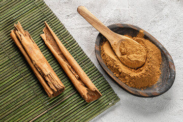 Cinnamon Sticks and Powder on Wooden Surface