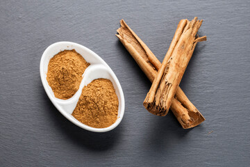 Cinnamon Sticks and Ground Spice on Slate