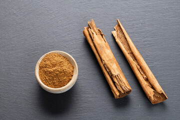 Cinnamon Sticks and Ground Spice on Slate