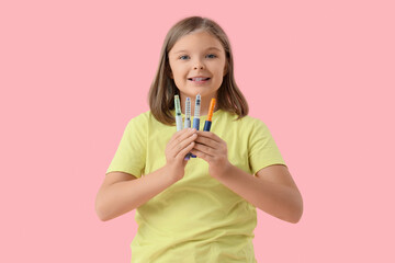 Diabetic girl with lancet pens on pink background