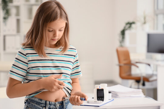 Diabetic girl using lancet pen in clinic