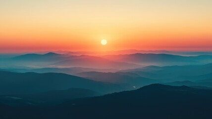Obraz premium Majestic sunrise over misty mountains showcasing vibrant colors and tranquil beauty