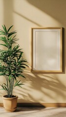A serene interior scene featuring a potted plant and a blank framed mirror against a textured wall, illuminated by soft natural light.