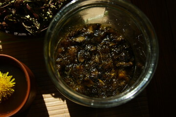 Dandelion honey jam, fresh and dried flowers in a beautiful aesthetic composition on the table.