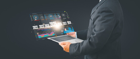 Trend 2025 for Business growth and industry concept, businessman using computer with symbol arrow up,stock graph and chart background, investment, Stock market and strategy for making market plan.