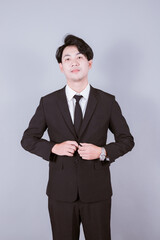 portrait of young handsome southeast Asian employee on blue background