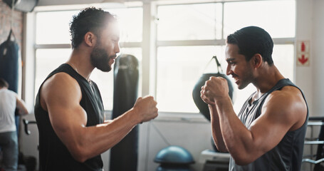 Naklejka premium Boxing, man and personal trainer in gym with fist bump, motivation and training for sport and strength in wellness club. Coach, smile and sweating athlete and boxer with exercise for fight and match