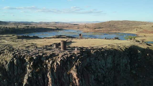 Aerial of Sillustani cliffs and tombs in Puno. Reverse Reveal
