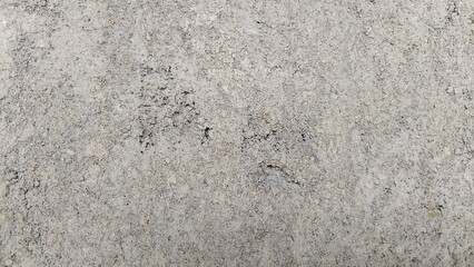 Textured Concrete Wall with Pockmarks and Rough Surface Details